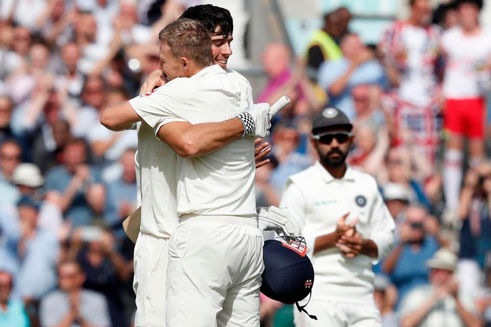  Previous captain Cook and current captain Root embrace as the former made his century