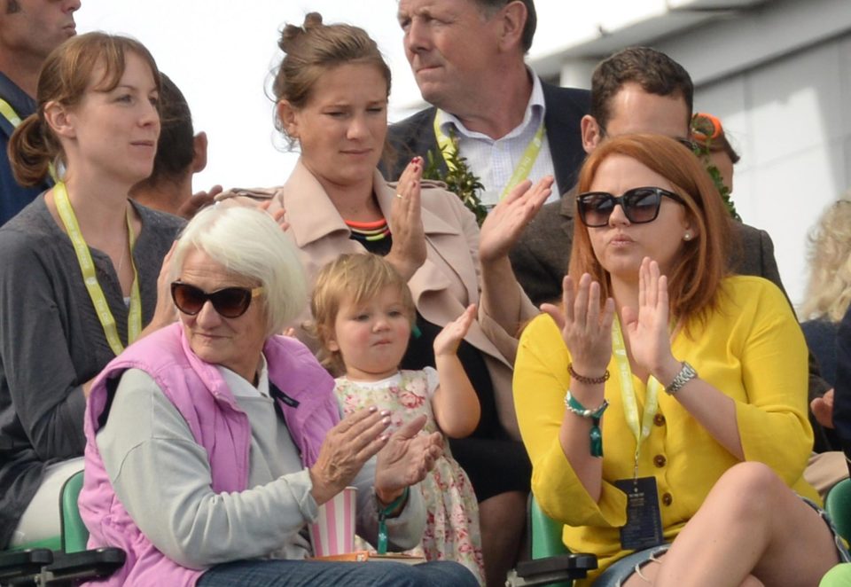 Alice Cook, in the beige coat, applauds as she sees husband Alastair bow out of Test batting with a century - on the day she is due to give birth to their third child