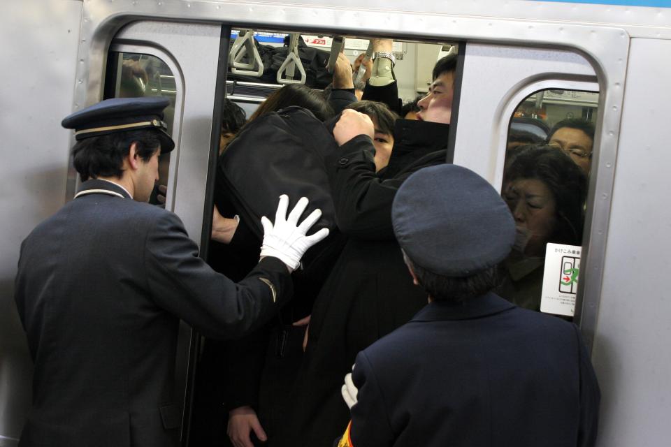  If you think your commute is bad, then spare a thought for those in Japan who literally find themselves being shoved onto a train so the doors can stay shut