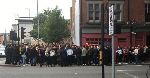  Crowds have gathered at the junction where the two cars collided