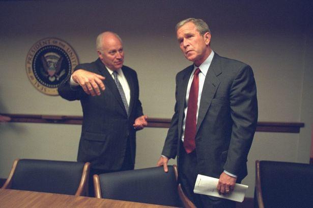  Then Vice President Dick Cheney confers with the President