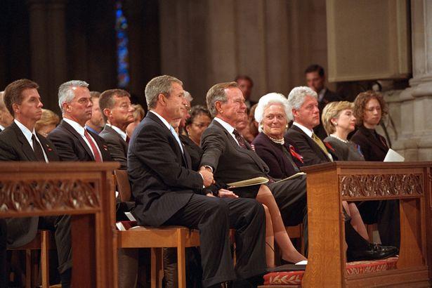  George W Bush attends a memorial service with his father, mother and Bill Clinton