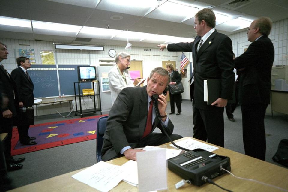  President George W Bush is briefed on events in an empty classroom in Florida