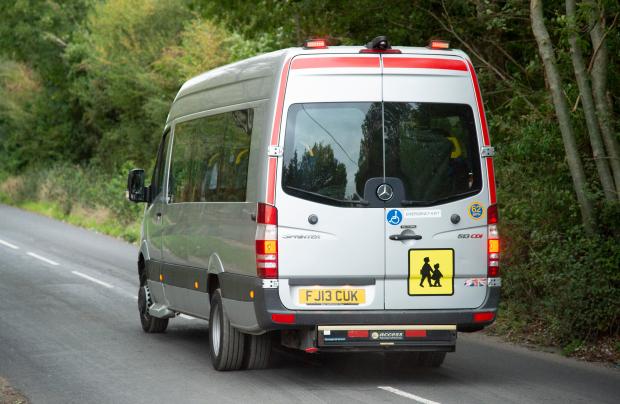 A minibus leaves the property, believed to be carrying the alleged victims of slavery