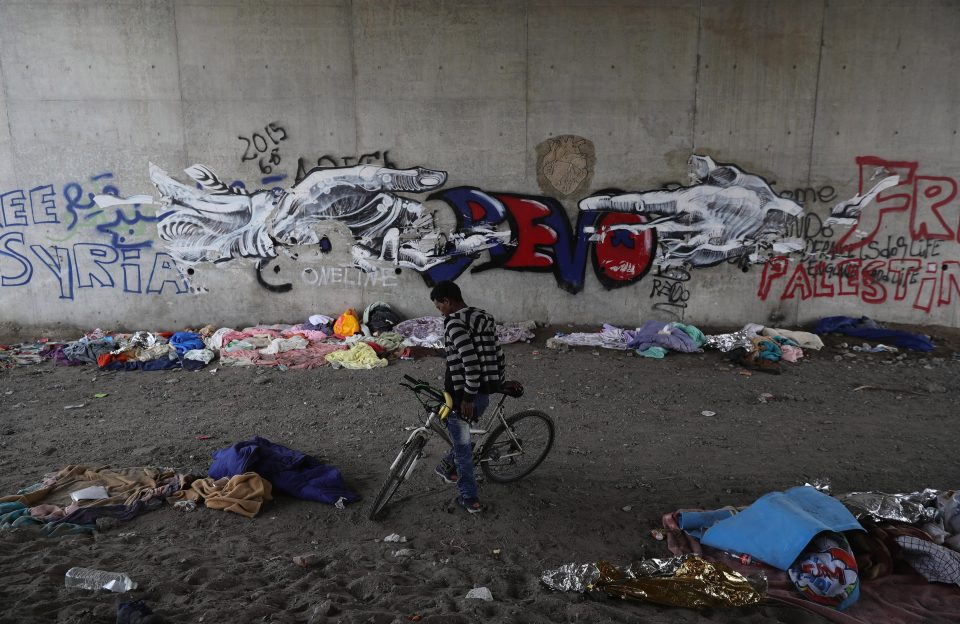  Migrants, many of whom were children, waited in the debris-strewn camp to go to the UK