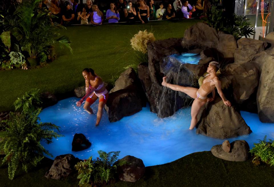  The models pranced and danced around this lush landscape, which even had its own water feature