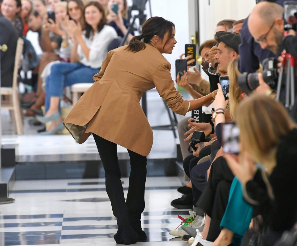  She walked out on the runway to take her bow and kiss her family