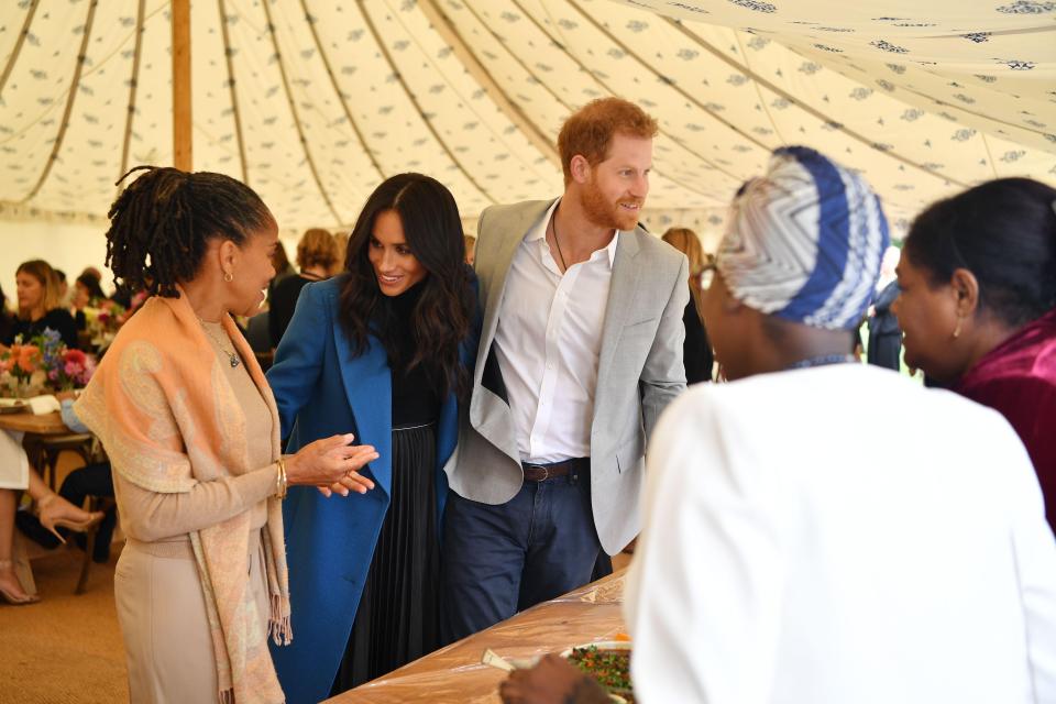  Prince Harry beamed as he joked with community members outside the marquee