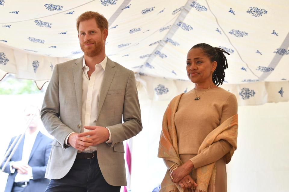  Harry and Doria listen as Meghan makes a speech