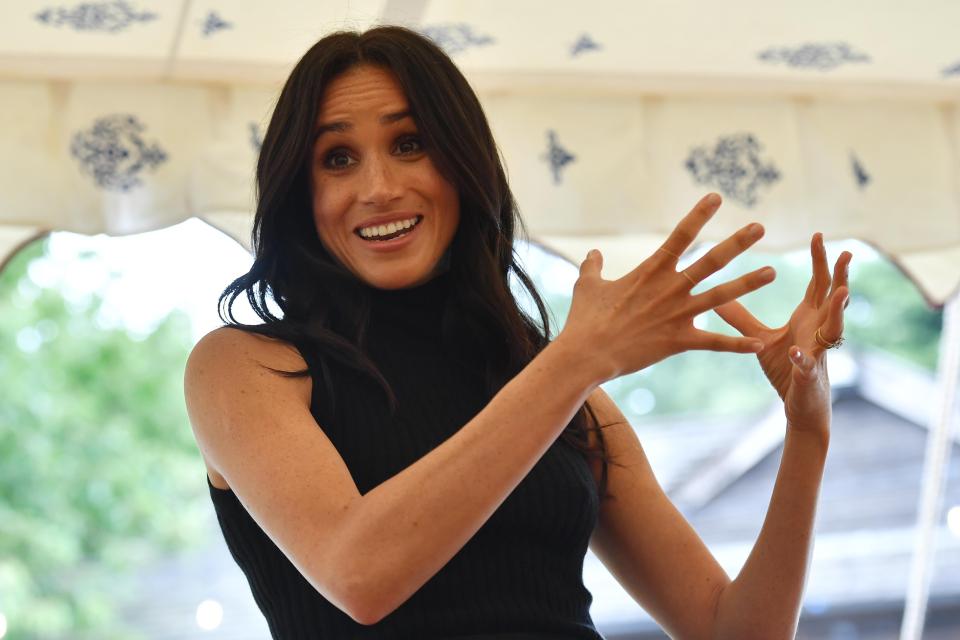  Meghan makes an emphatic gesture in her speech