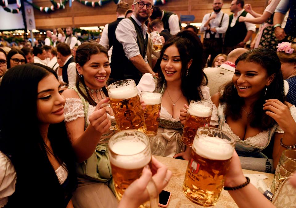  Visitors cheer with beers during the opening day of the Oktoberfest last year