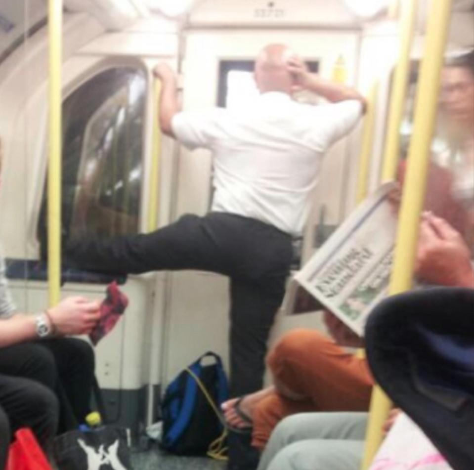  It's not clear why this man is trying to get a leg up on other commuters