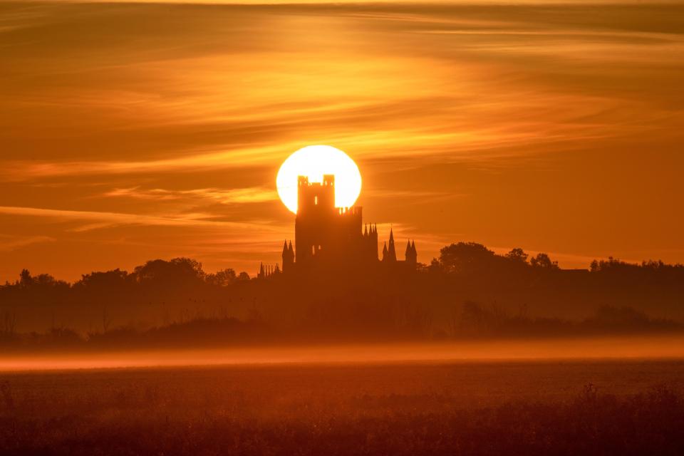  The thousand-year-old building was silhouetted by the sunrise this morning