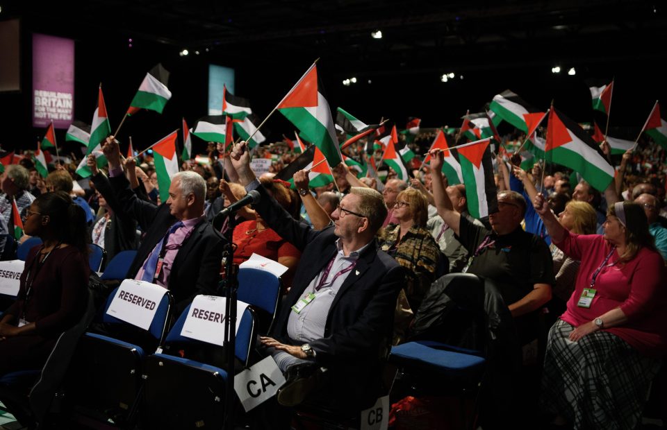  Delegates including union baron Len McCluskey waving Palestinian flags at Labour conference