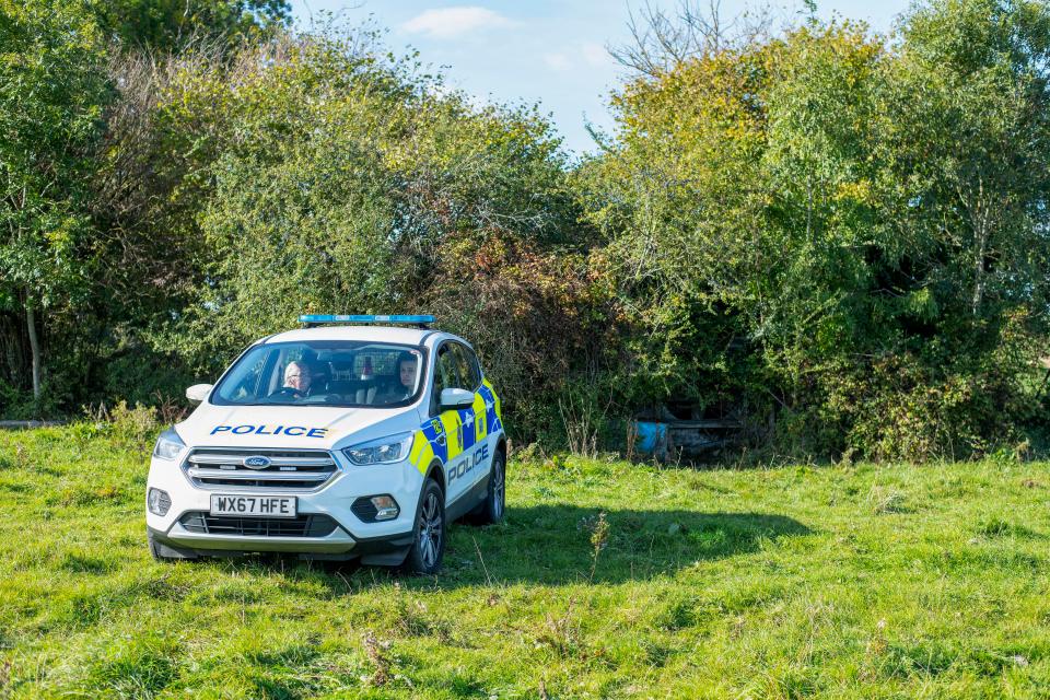  A cop car guards the quarry as investigations continue