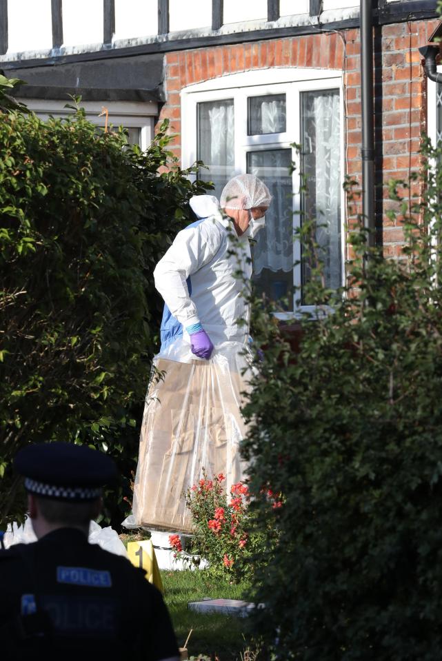  A forensics officer carries a huge bag of evidence as a murder investigation into the death of two women gets underway