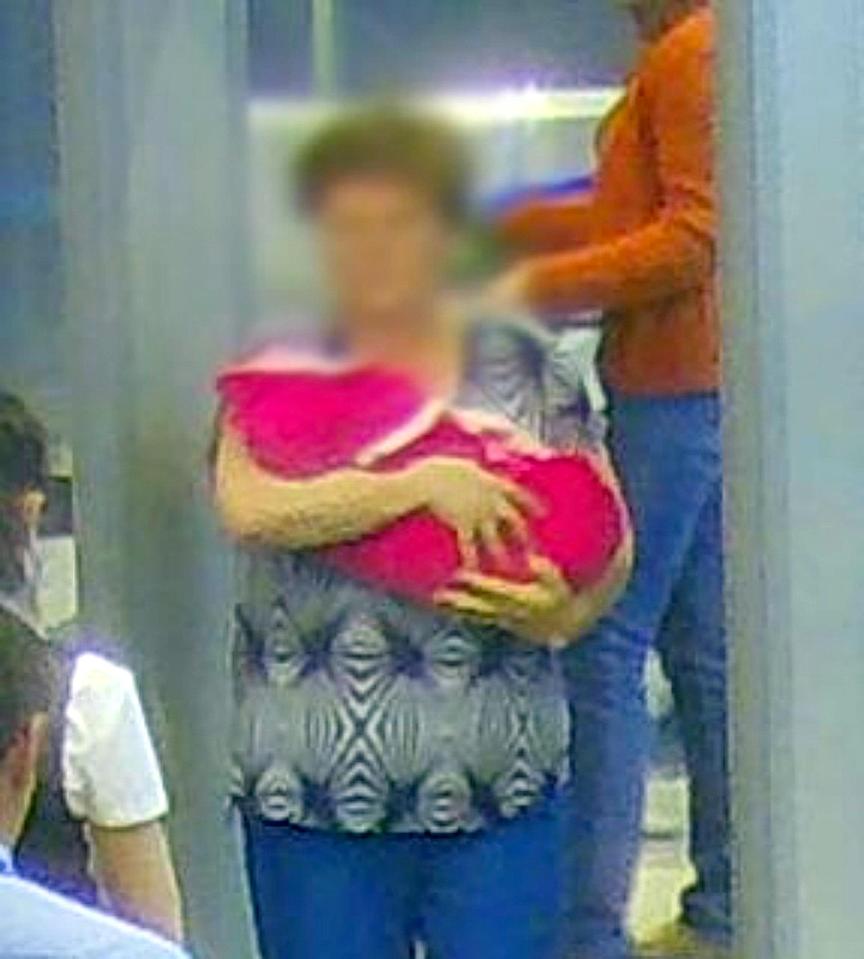  The teacher is seen carrying off the baby girl at the airport