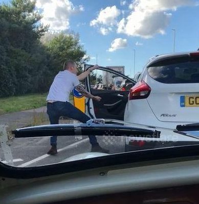  The man hops out of his car to perform the dance during a traffic jam