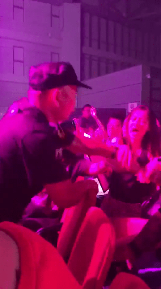  This Shanghai officer drags a young girl who was dancing and singing as Dua Lipa performed out of her seat