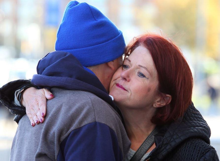  Two fans console each other at the stadium