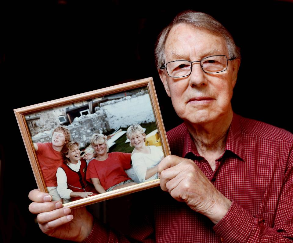  Suzy's father in 2016 holding up a photo of his four children: (L-R) Richard, Suzy, Tamsin and Lizzy taken in the early 1980s