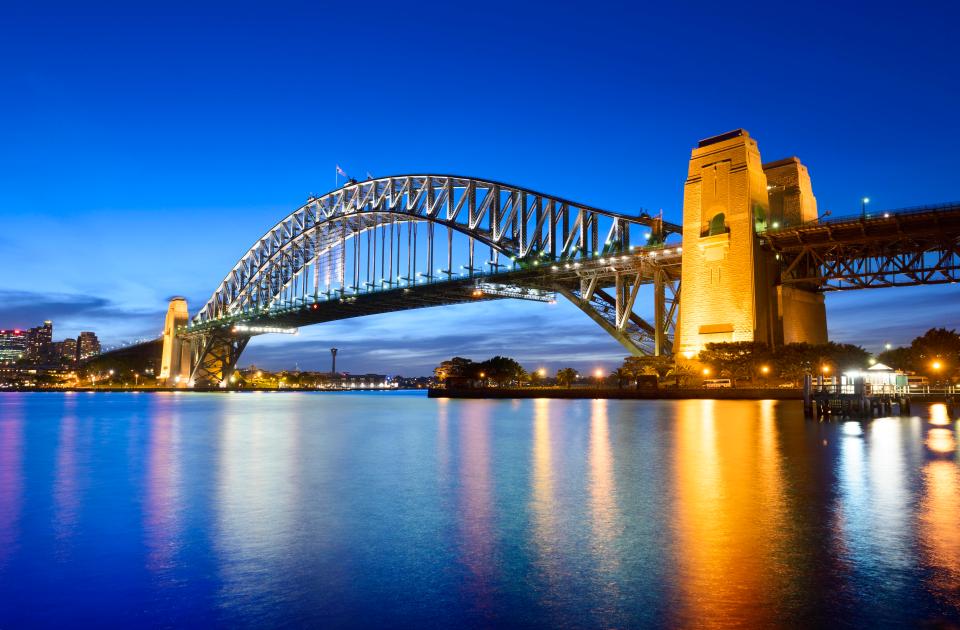  Sydney Harbour Bridge looks beautiful at twilight with the clear blue sky's reflection in the still water