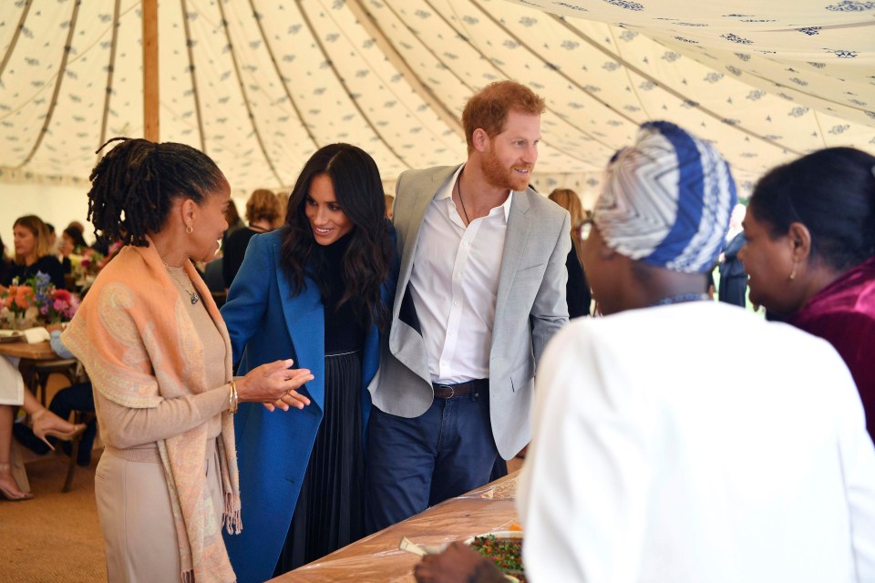 Meghan, the Duchess of Sussex, centre, talks to her mother Doria Ragland, with Prince Harry at centre right, as they attend a reception for the cookbook Together, at Kensington Palace, in London