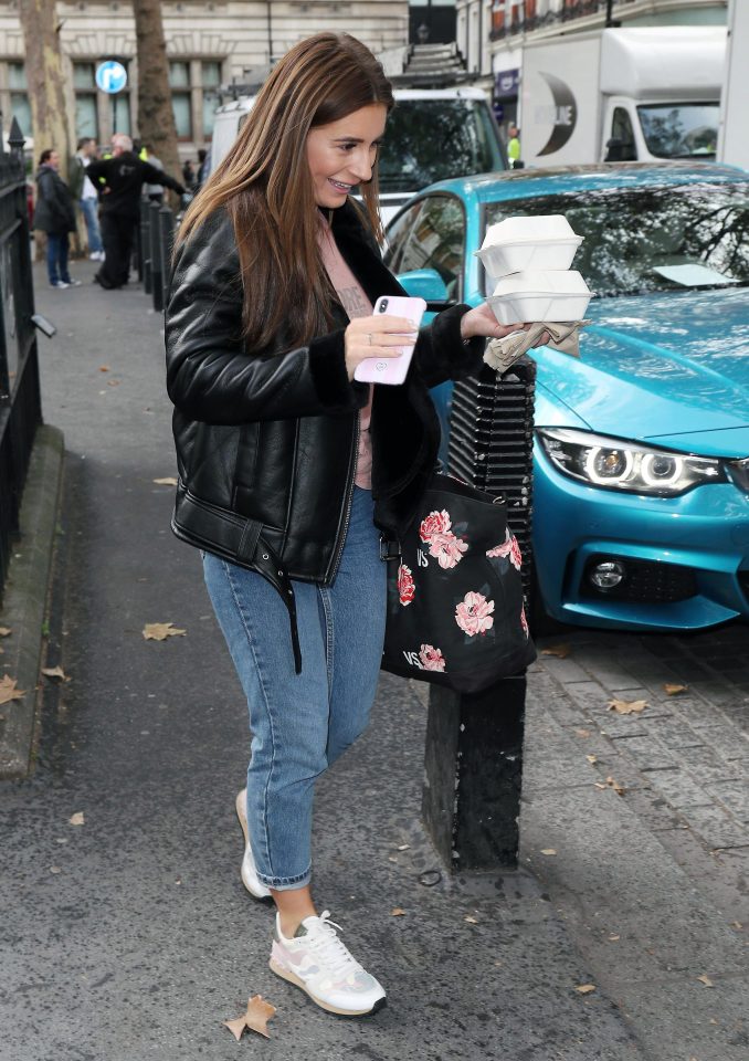 She laughed after the eventful morning as she headed to her next meeting, with her breakfast in hand