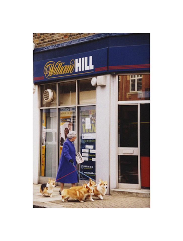  The Queen passes a bookies as she heads out for a Sunday walk with her corgis to grab a newspaper