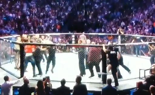 A third man jumped in and made his way for McGregor as security stepped in