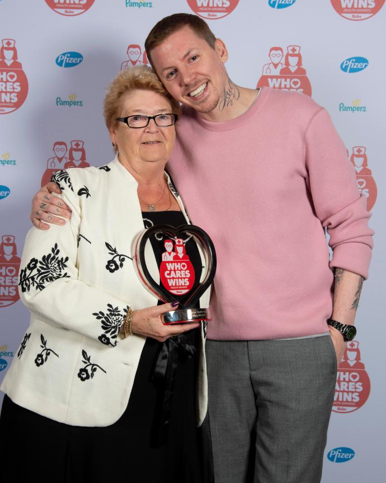  Patients helper Mary Mitchell, 71, with her award presenter Professor Green