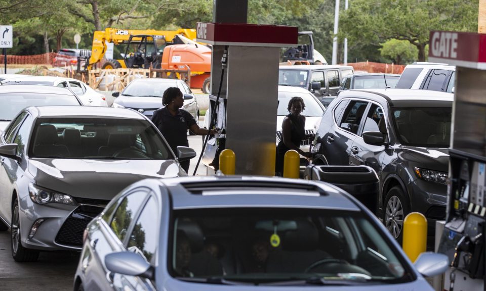  Drivers fill their cars after being warned to flee their homes