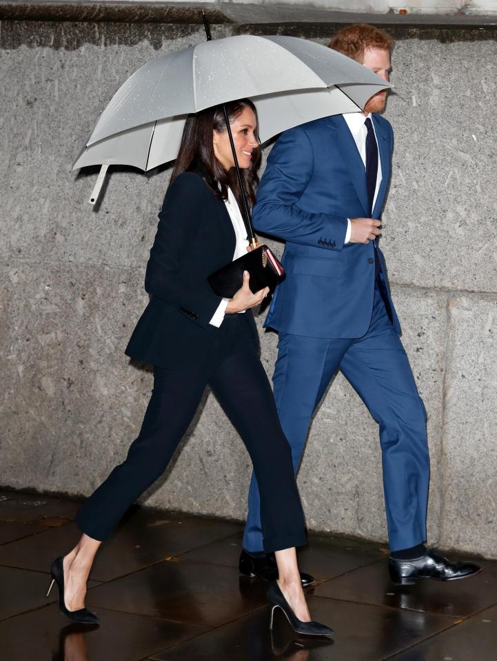  Sheltering from the rain in a neat black suit