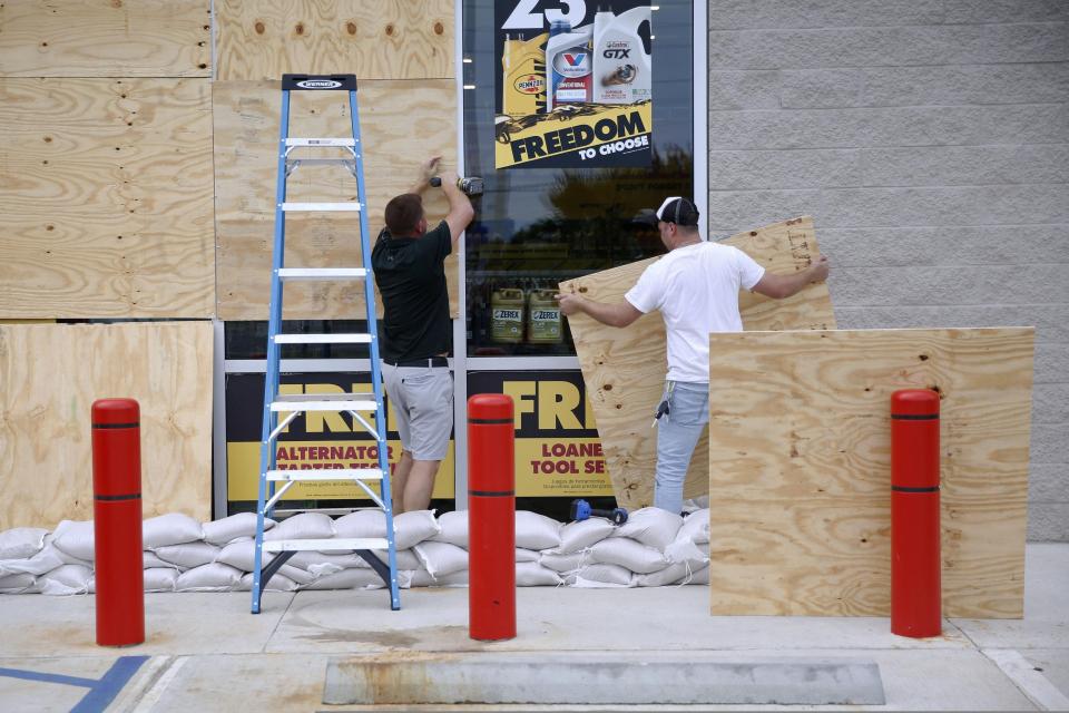  Justin Davis, left, and Brock Mclean board up a business in advance of Hurricane Michael in Destin, Florida