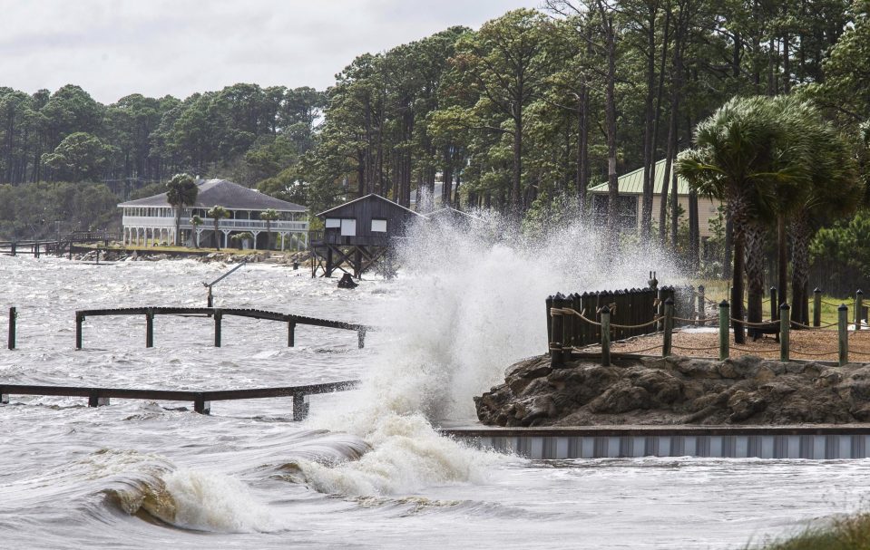  Waves are beginning to crash against a seawall in Eastpoint, Florida