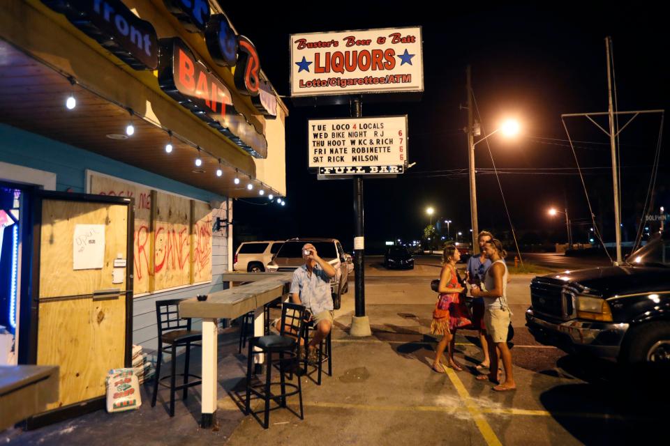  Drinkers at the boarded-up Buster's Beer & Bait bar, Panama City Beach,Florida who have decided to ride out the storm