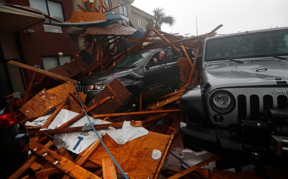  A storm chaser climbs into his vehicle during the eye of Hurricane Michael to gather his belongings