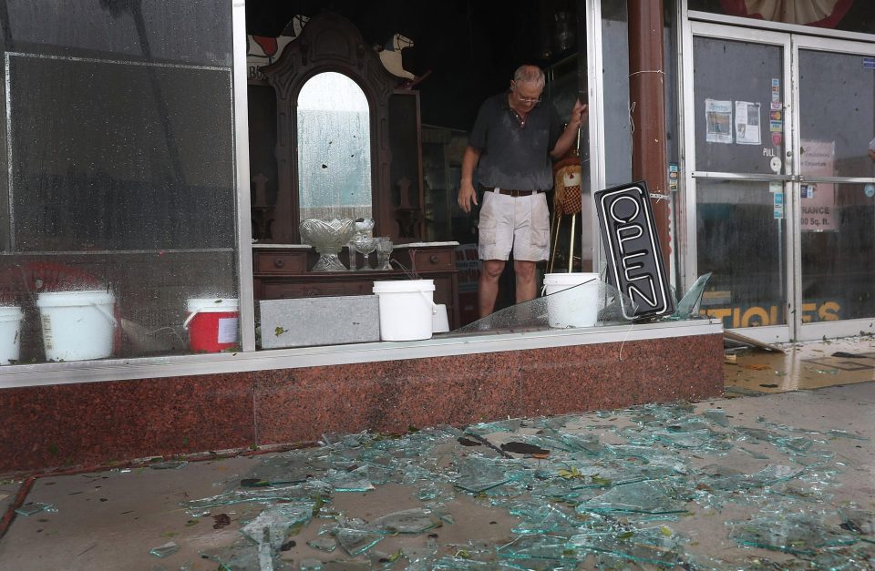  Mike Lindsey stands in his antique shop after the winds from hurricane Michael broke the windows