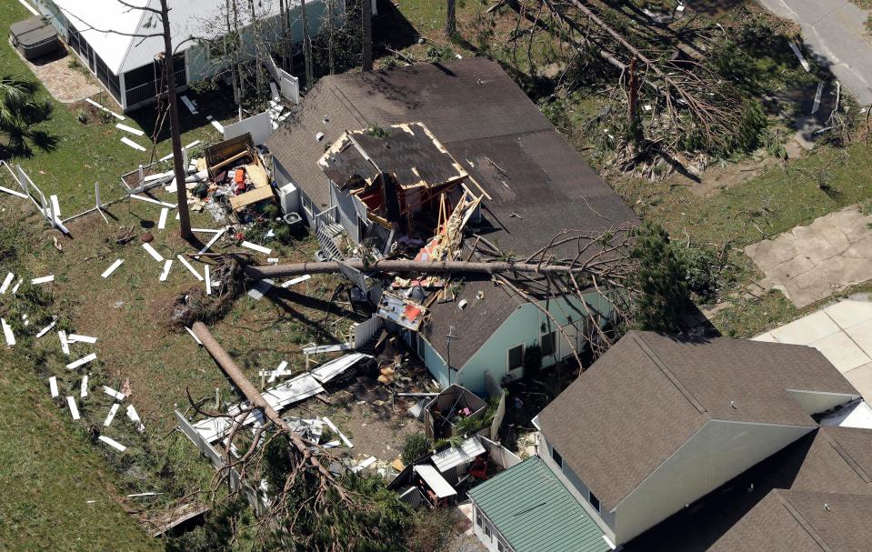  A house is seen with huge gaping holes in its roof