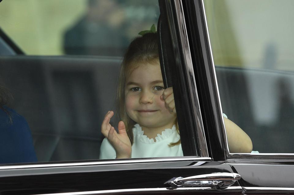  Princess Charlotte waves at the crowds gathered for the wedding