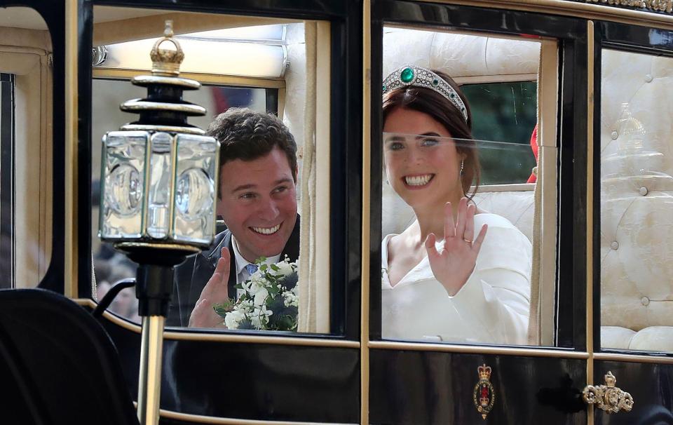  Newlyweds Princess Eugenie and Jack Brooksbank beam as they wave from the royal carriage