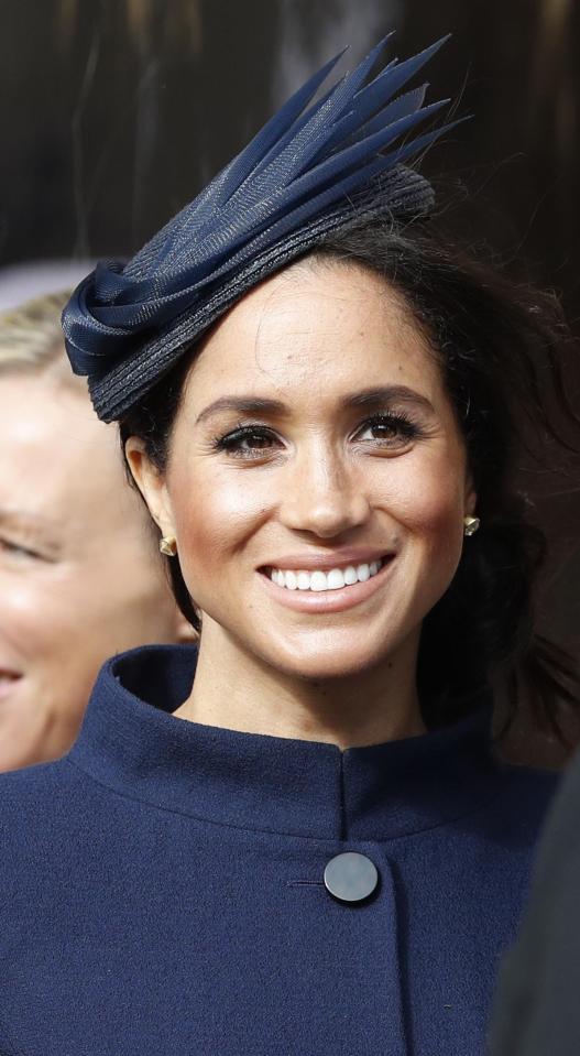  The Duchess of Sussex complemented her sophisticated navy outfit with a simple hat of the same colour