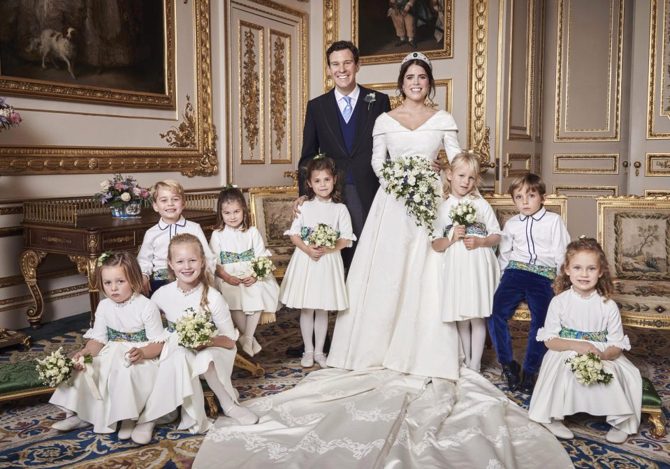  Little Mia Tindall, four, pictured far left, looked less than impressed as she posed for Princess Eugenie and Jack Brooksbank's official wedding photos, and was clutching an unidentified white object in her left hand