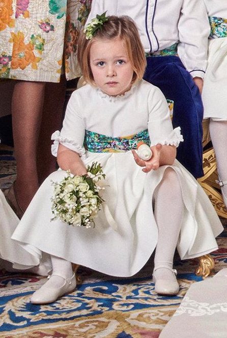 The four-year-old failed to crack a smile in either of the wedding pictures