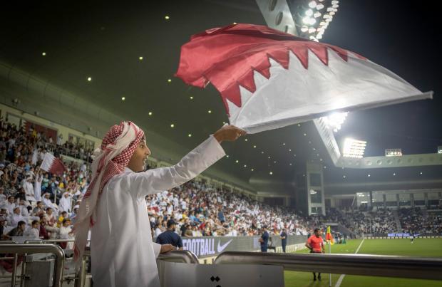 A young Qatar fan waves the national flag in a dramatic 4-3 friendly win over Ecuador