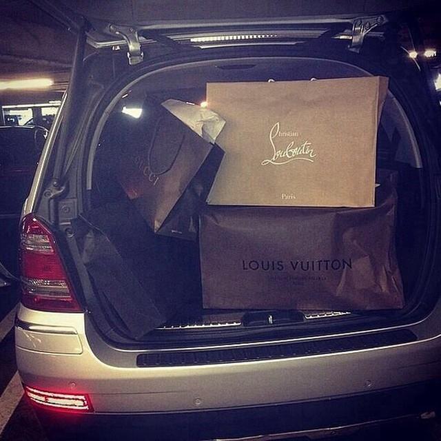 This enormous car boot is jammed full of bags from designer clothes stores 