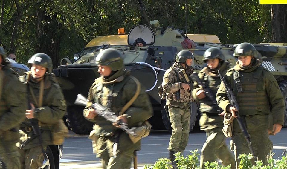 Federal National Guard officers near the building of the Kerch Polytechnic Vocational School in the city of Kerch, Crimea, Russia, in the aftermath