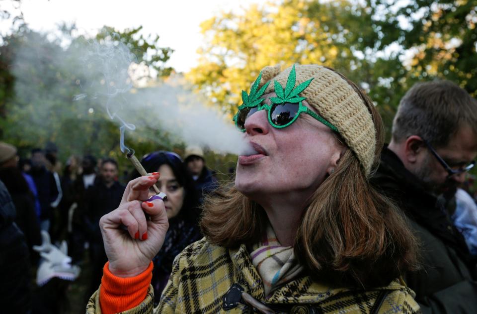  One happy pot-lover exhales a plume of smoke as she celebrates the ban being lifted in Canada