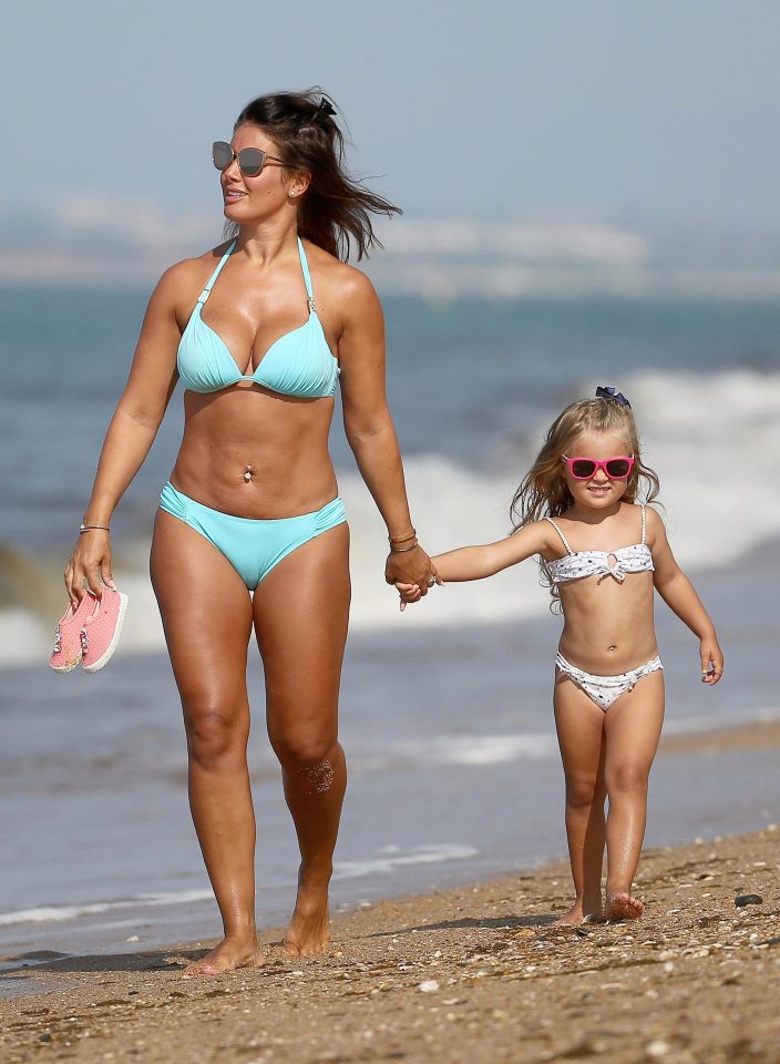 Becky Vardy showed off her enviable figure during a beach day with her daughter Sofia (above) and son Finley in Portugal today