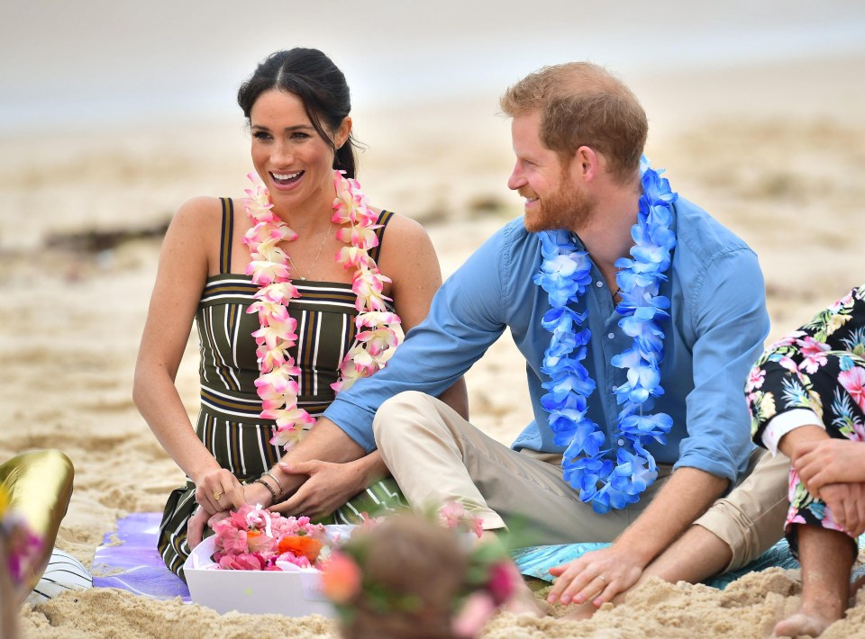 Meghan is wearing a striped khaki maxi dress by Martin Grant